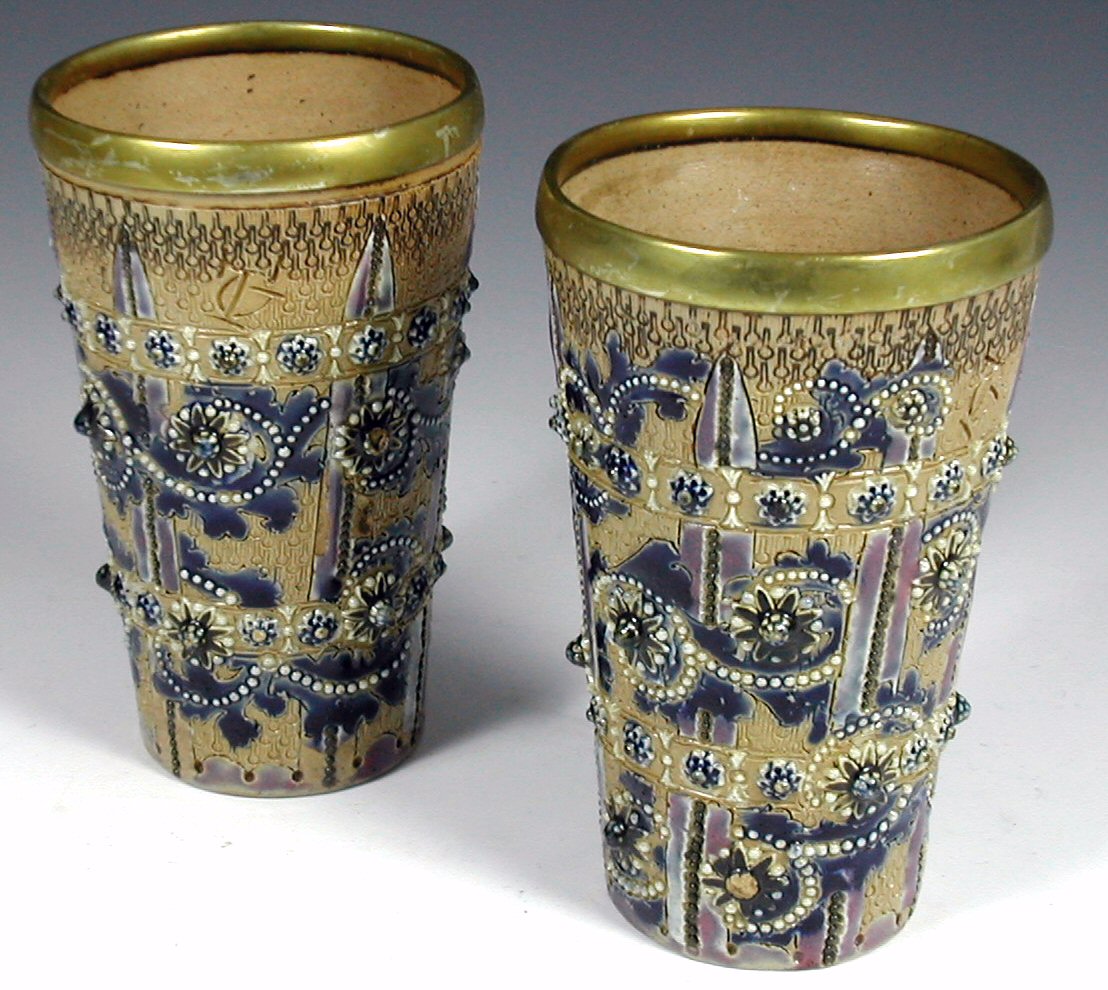 A pair of Doulton Lambeth stoneware beakers,