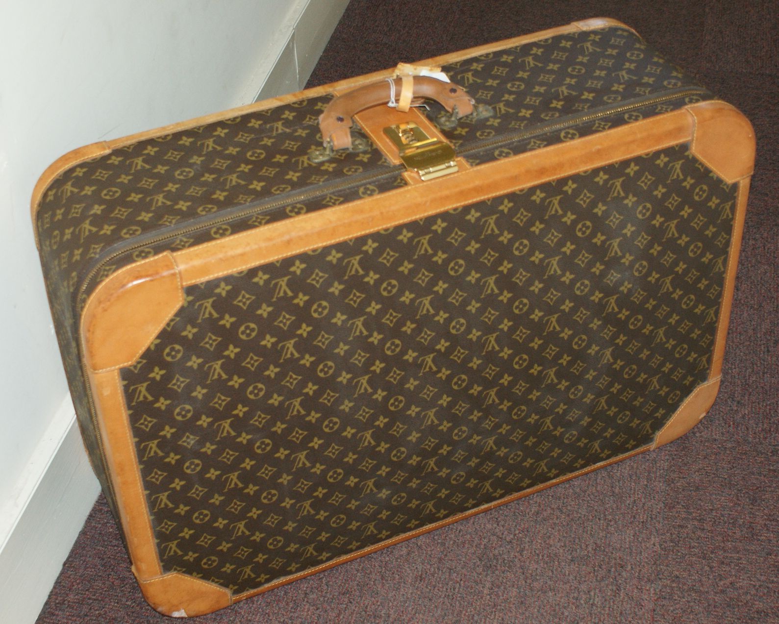 LOUIS VUITTON - A large hard sided suit case
