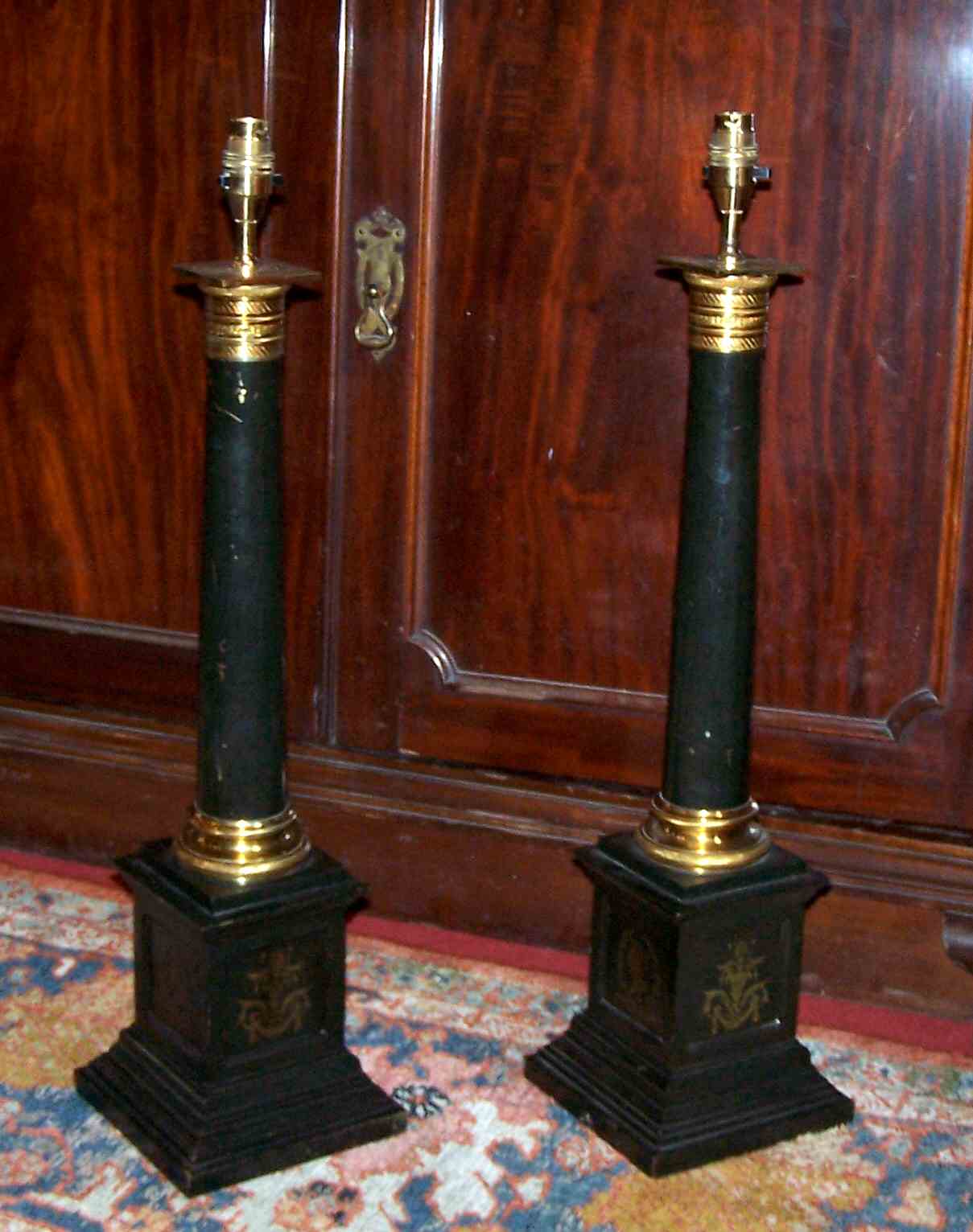 A pair of French gilt brass and japanned table lamps
