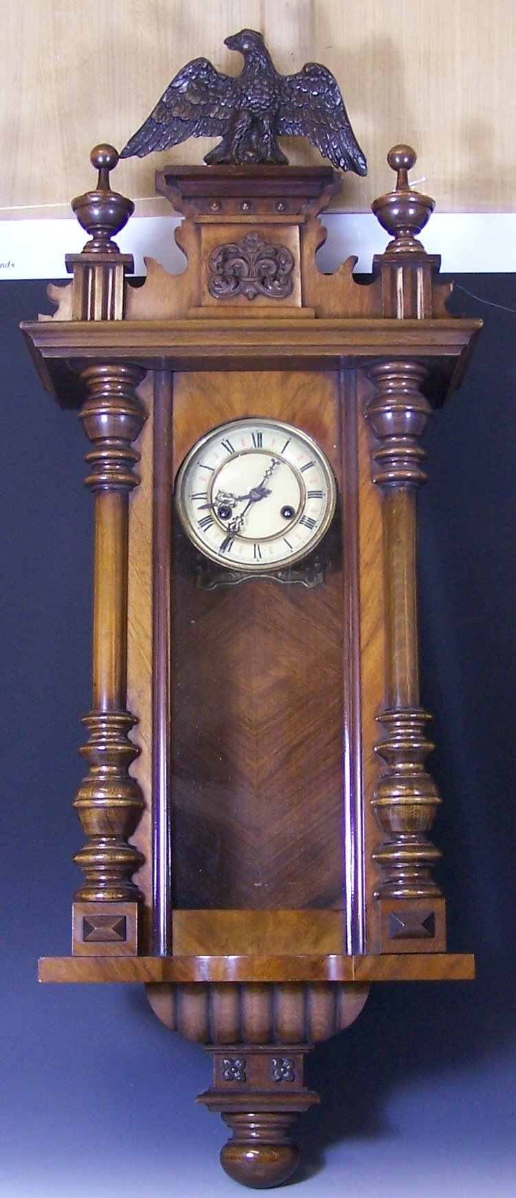 A late 19th century walnut and stained beech Viennese wall clock,