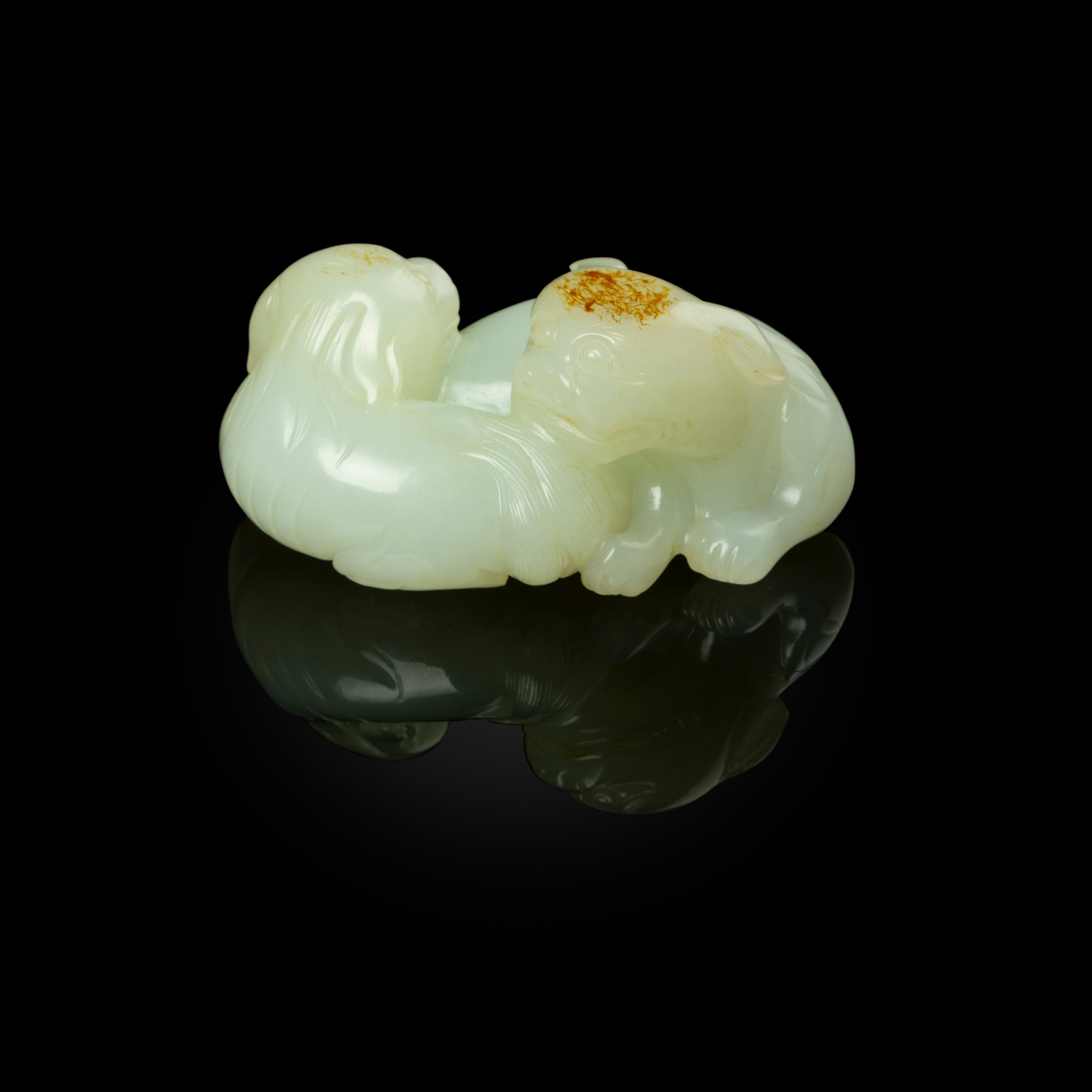 CHINESE WHITE JADE WITH RUSSET SKIN CARVING OF TWO BUDDHIST LIONS