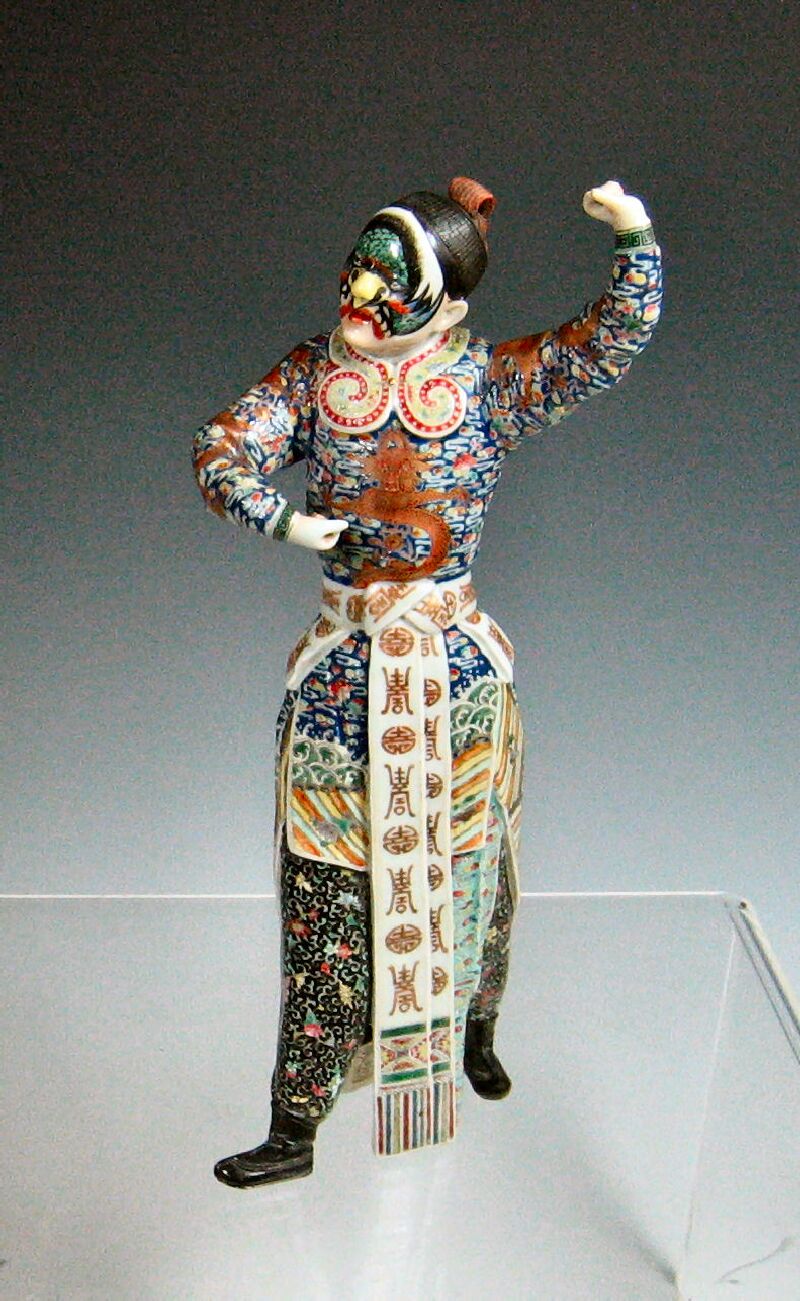 A ceramic figure of a theatrical masked man