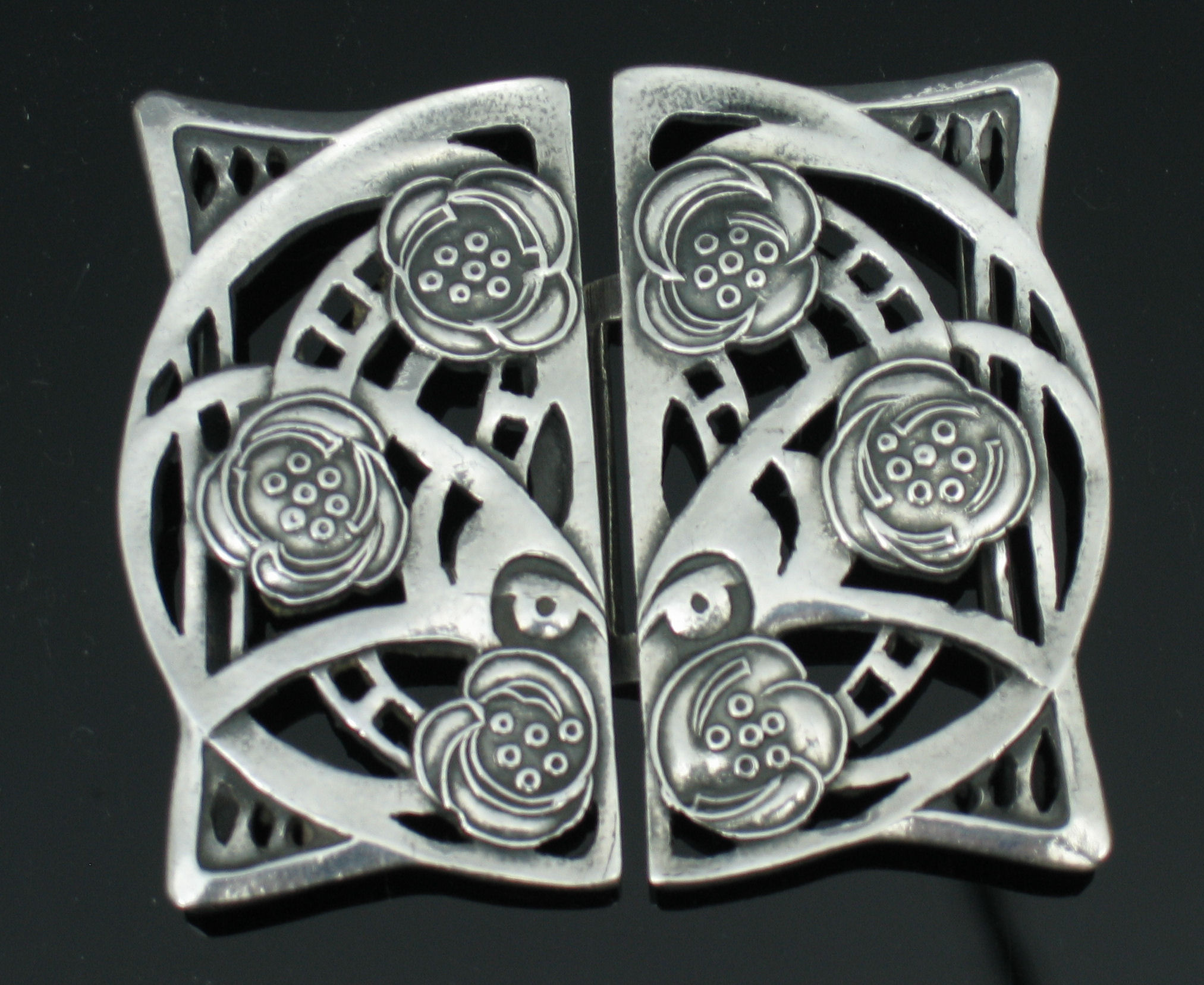 Jessie M. King (1875 - 1949) A silvered belt buckle,