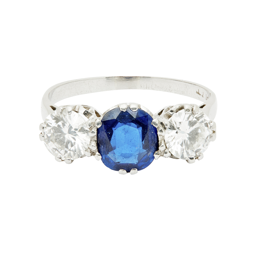 A sapphire and diamond set three stone ring