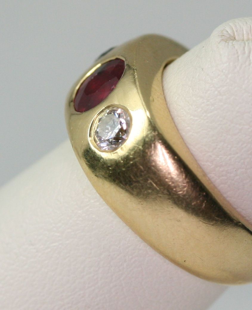 A ruby and diamond three-stone ring