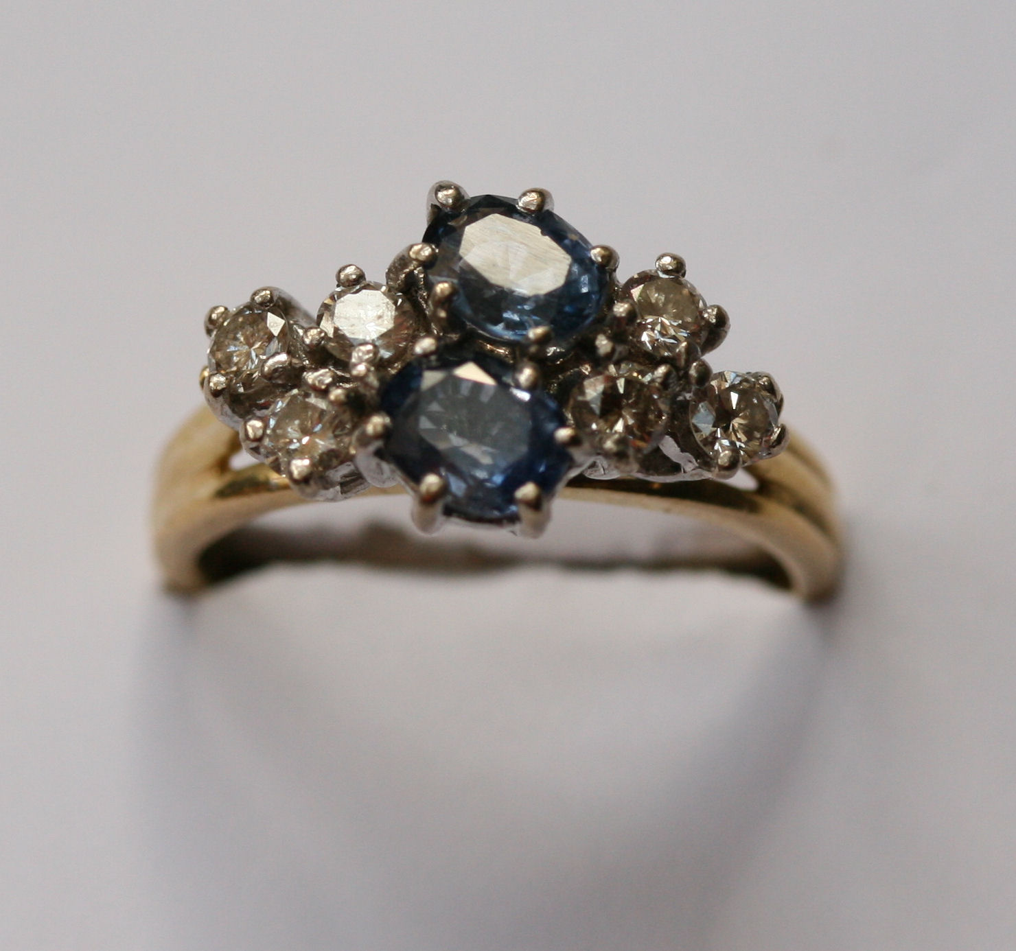 An 18ct yellow gold two stone sapphire and diamond ring