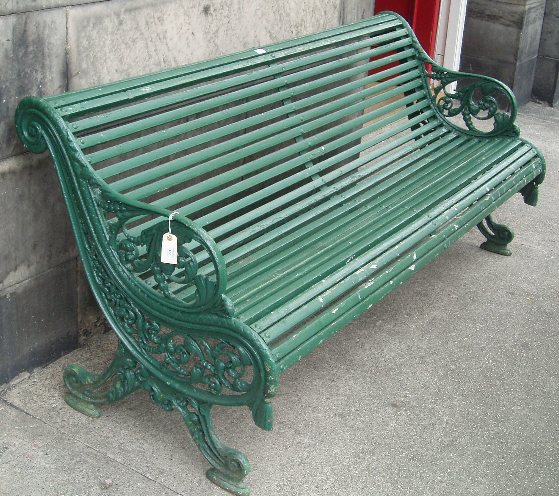 A Victorian overpainted cast iron garden bench,