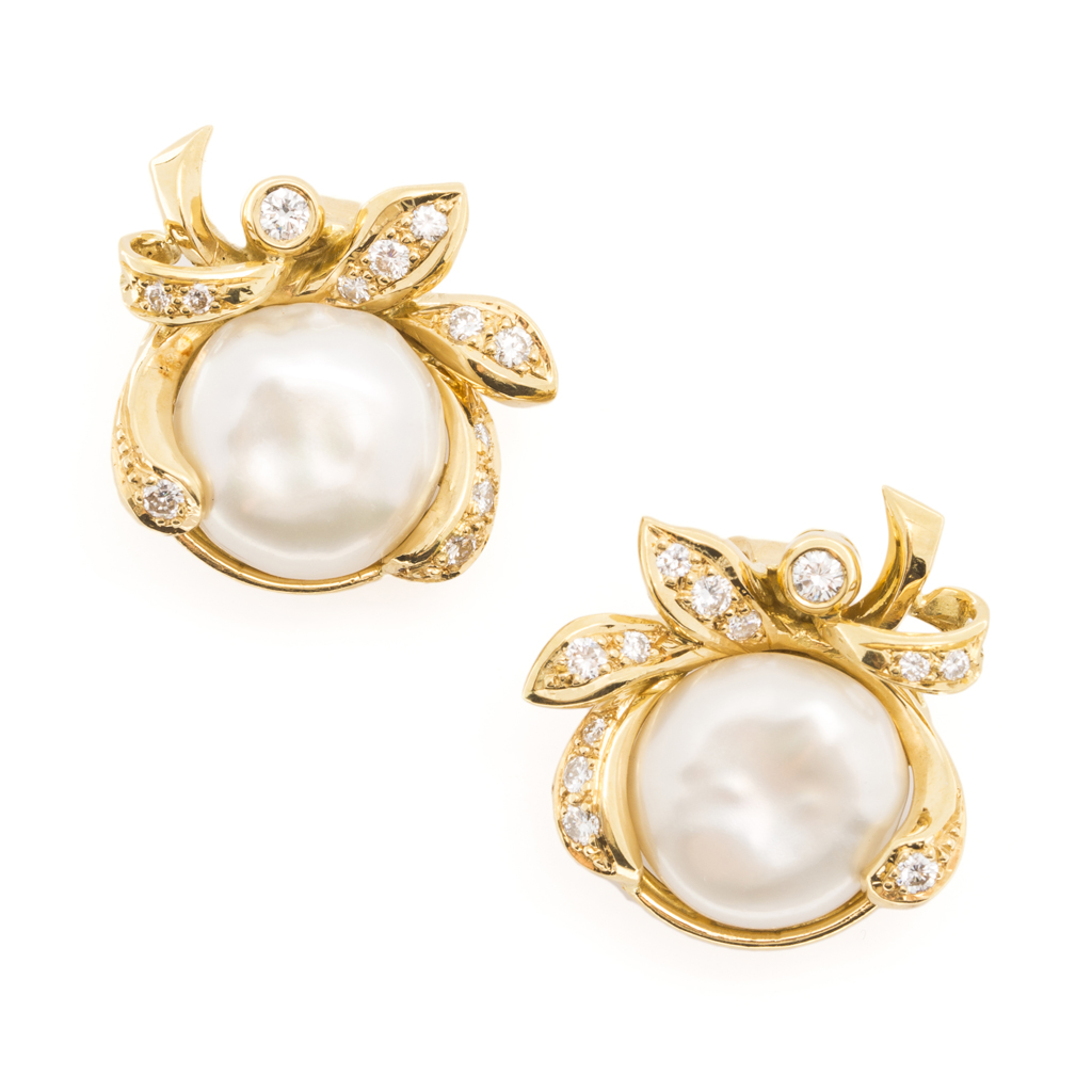 A pair of pearl and diamond set earrings
