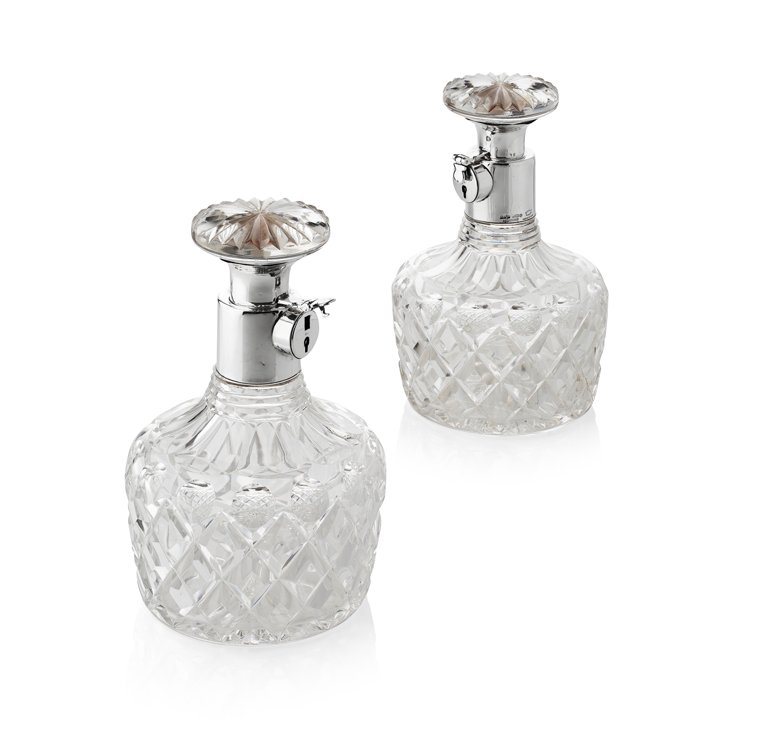 PAIR OF ASPREY CUT GLASS AND SILVER MOUNTED LOCKING DECANTERS