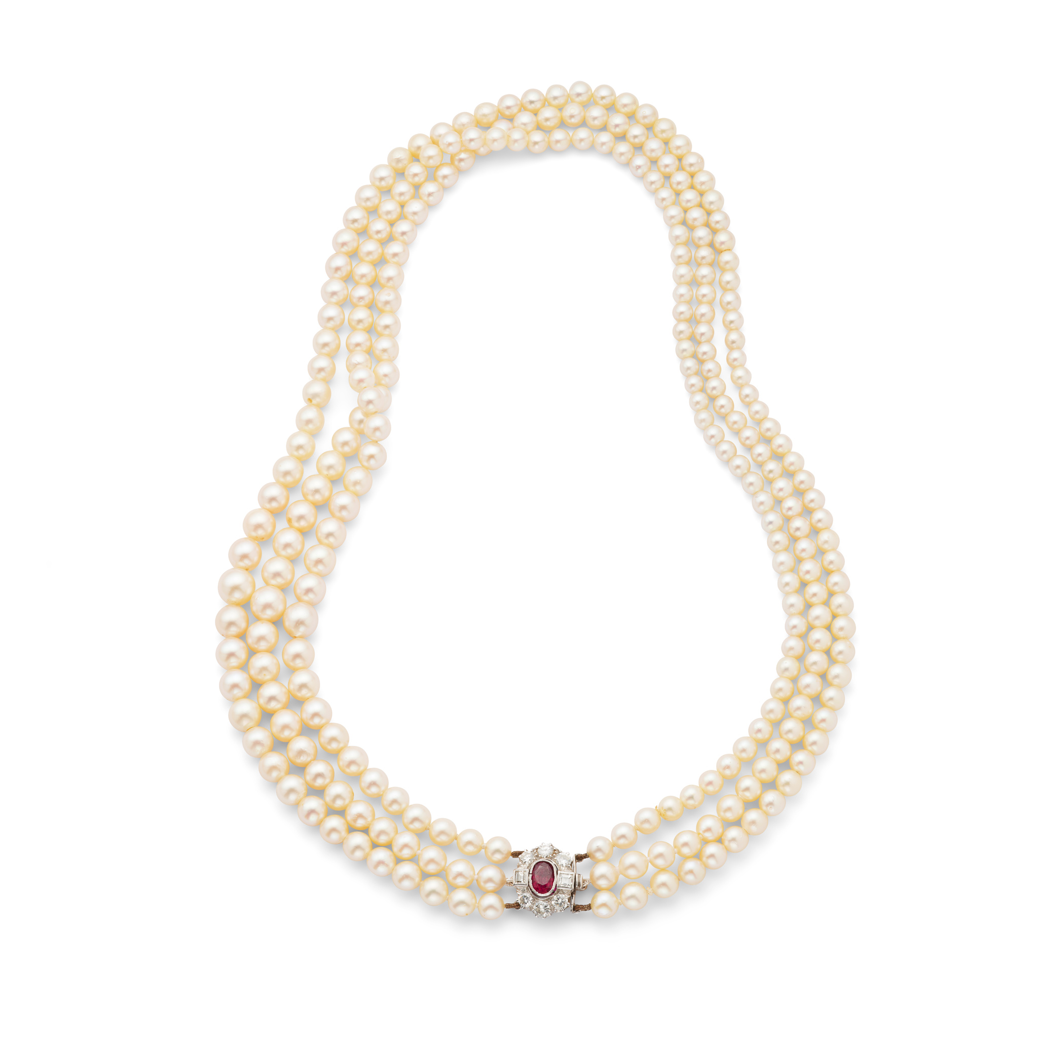 A three-strand cultured pearl necklace with a ruby and diamond clasp