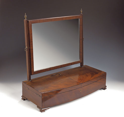 A Regency mahogany bowfront dressing mirror