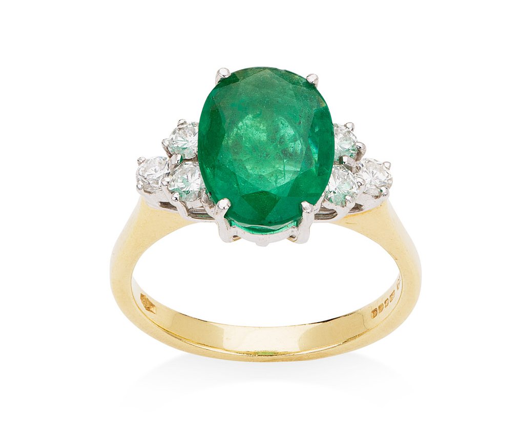 A modern 18ct gold mounted emerald and diamond set ring