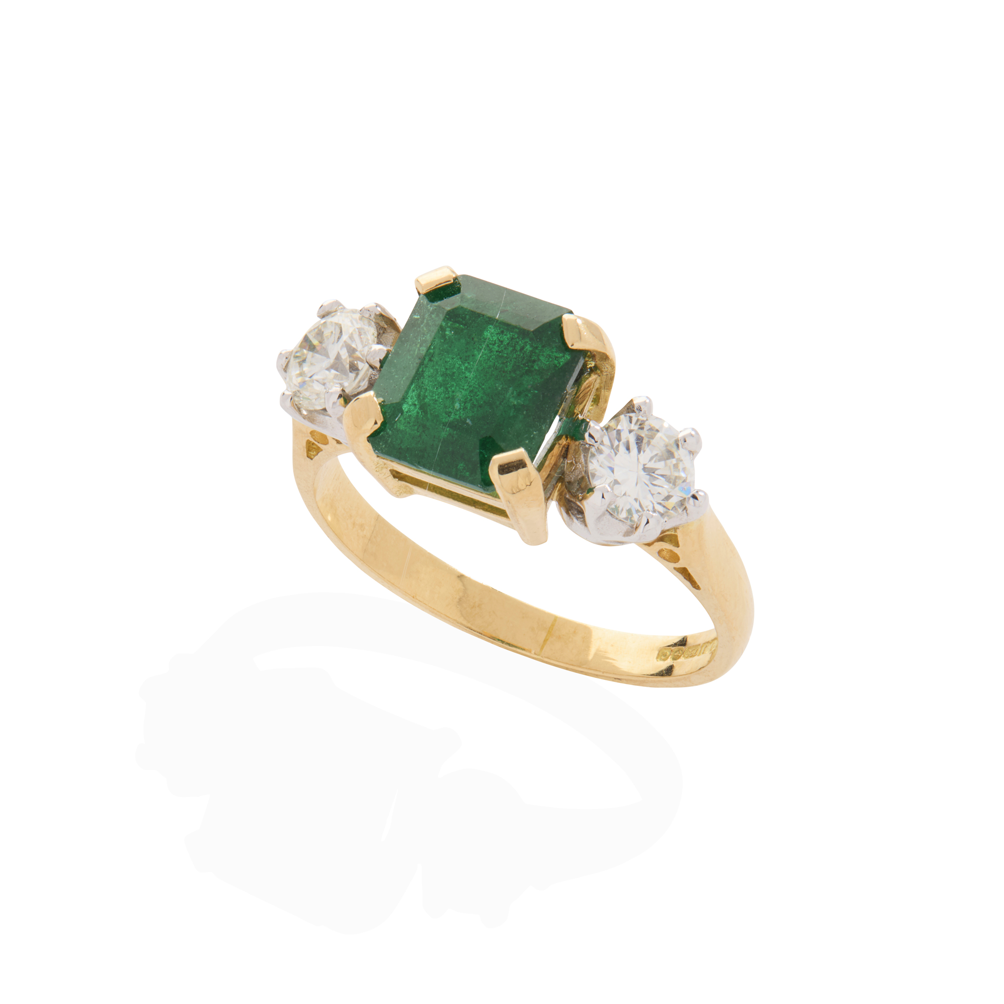 An 18ct yellow gold emerald and diamond three-stone ring