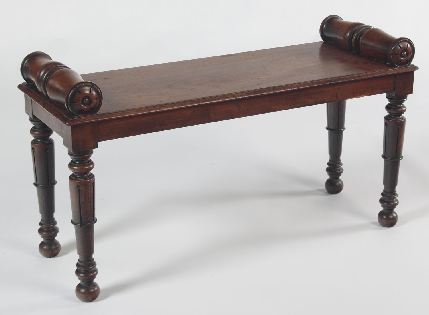 A William IV mahogany long library stool