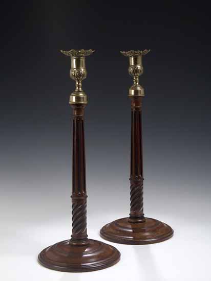 A pair of George III mahogany candlesticks