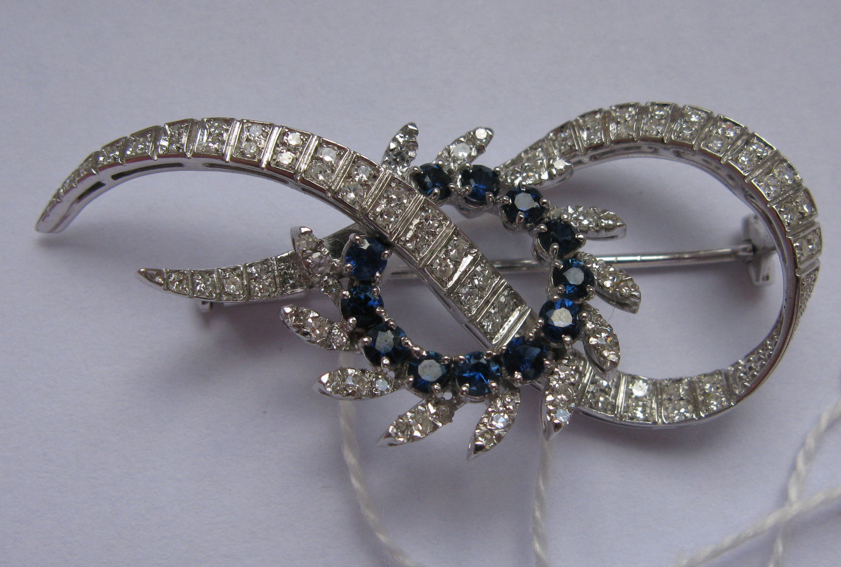 A modern sapphire and diamond set foliate spray brooch