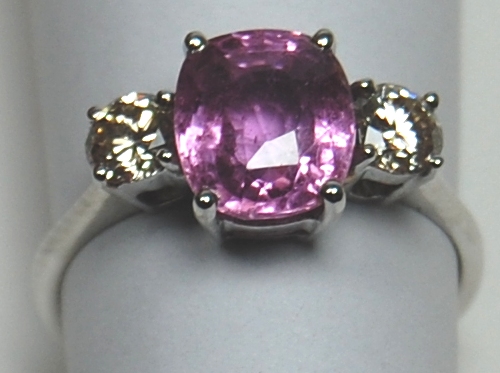 A modern lilac sapphire and diamond three-stone ring,