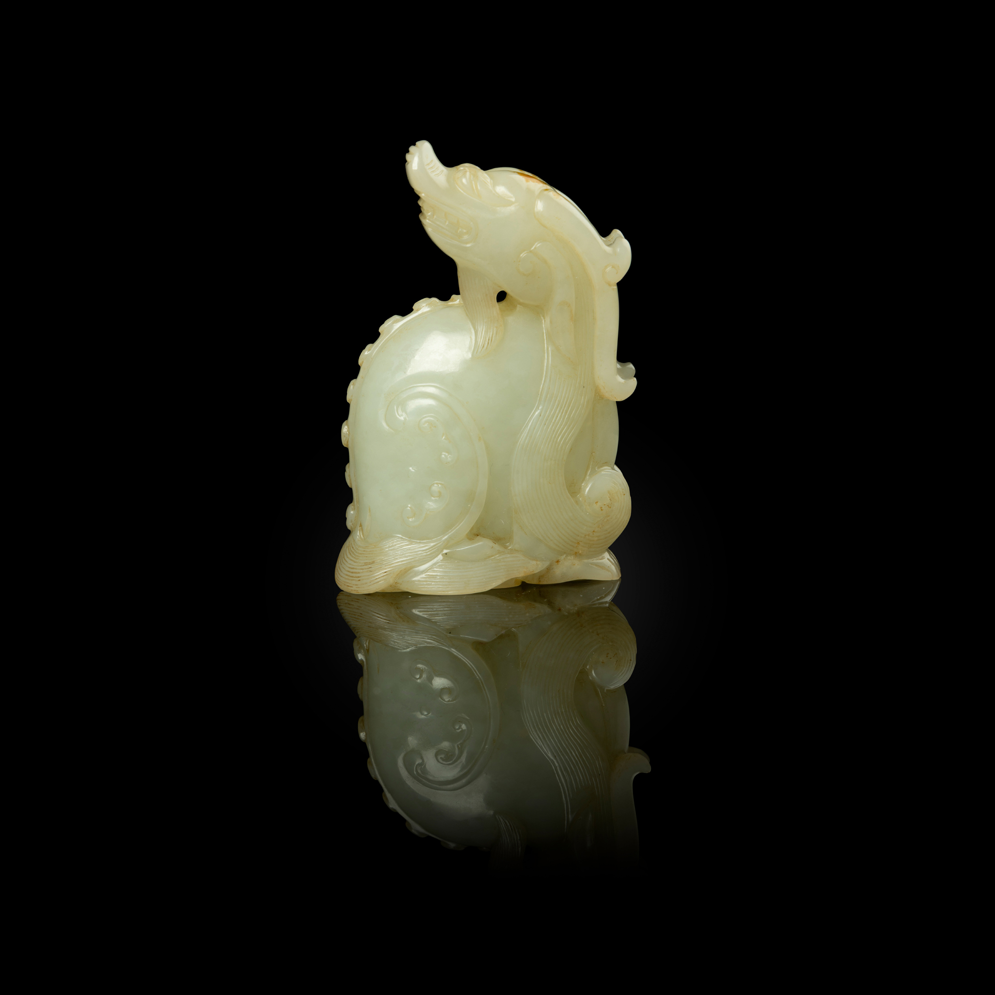 CHINESE WHITE JADE WITH RUSSET SKIN CARVING OF A MYTHICAL ANIMAL, TIANLU