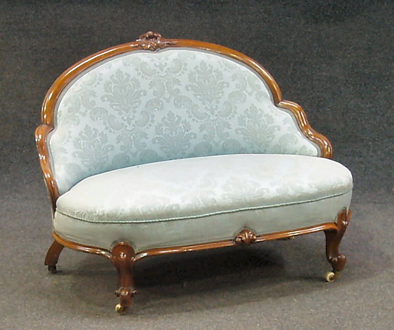 A Victorian walnut and upholstered small settee