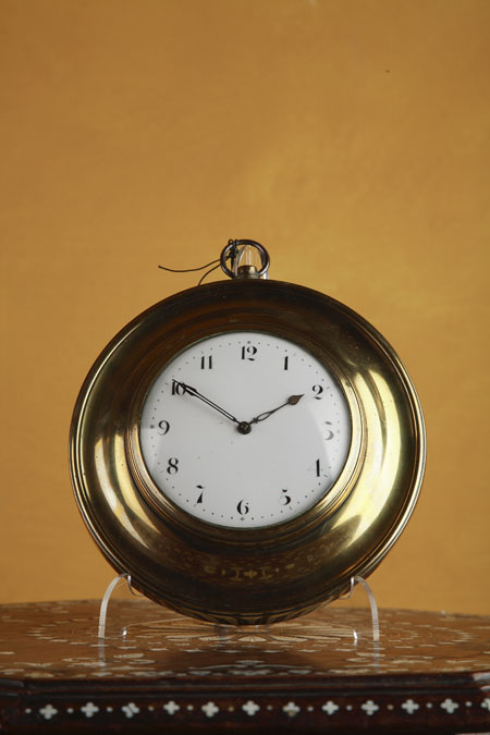A small early 19th century brass sedan clock