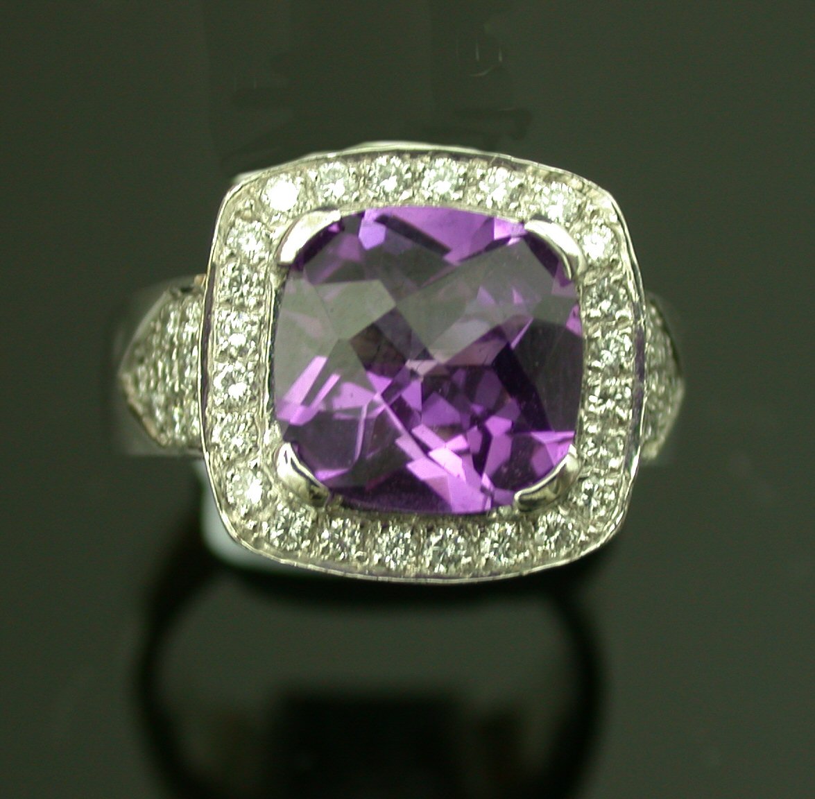 An 18ct white gold mounted amethyst and diamond cluster ring,