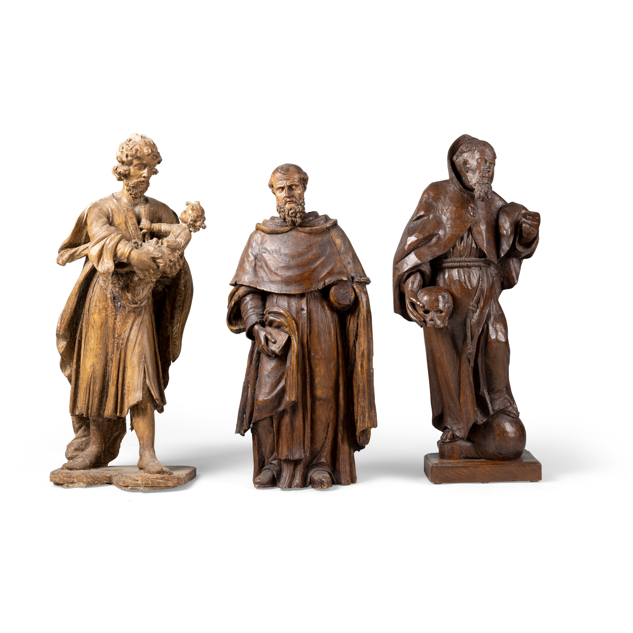 A CARVED OAK FIGURE OF A MONK HOLDING A SKULL