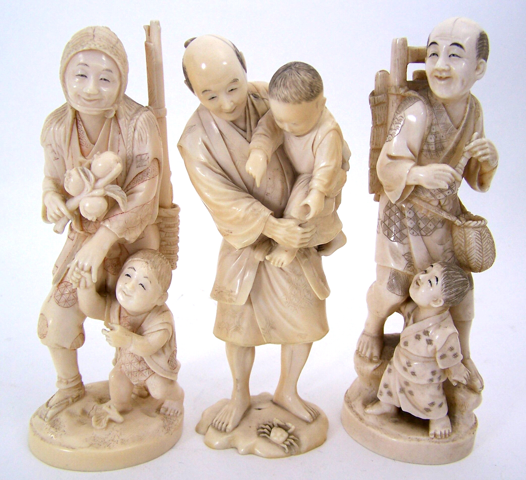 A collection of three Japanese ivory figure groups,
