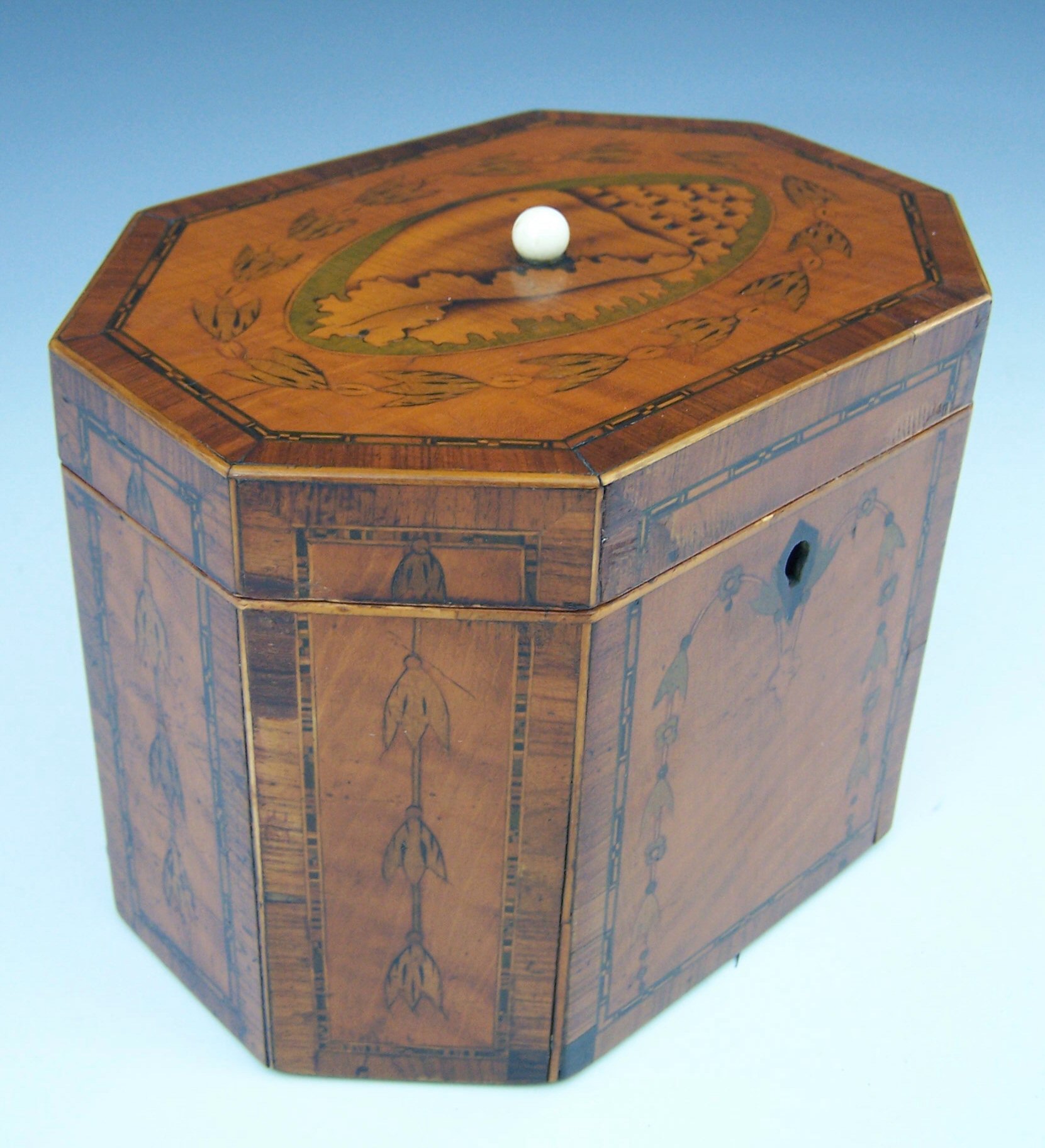A George III satinwood, chequer strung and tulipwood crossbanded octagonal tea caddy,