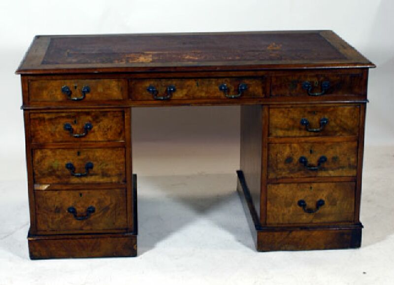 An Edwardian burr walnut twin pedestal desk