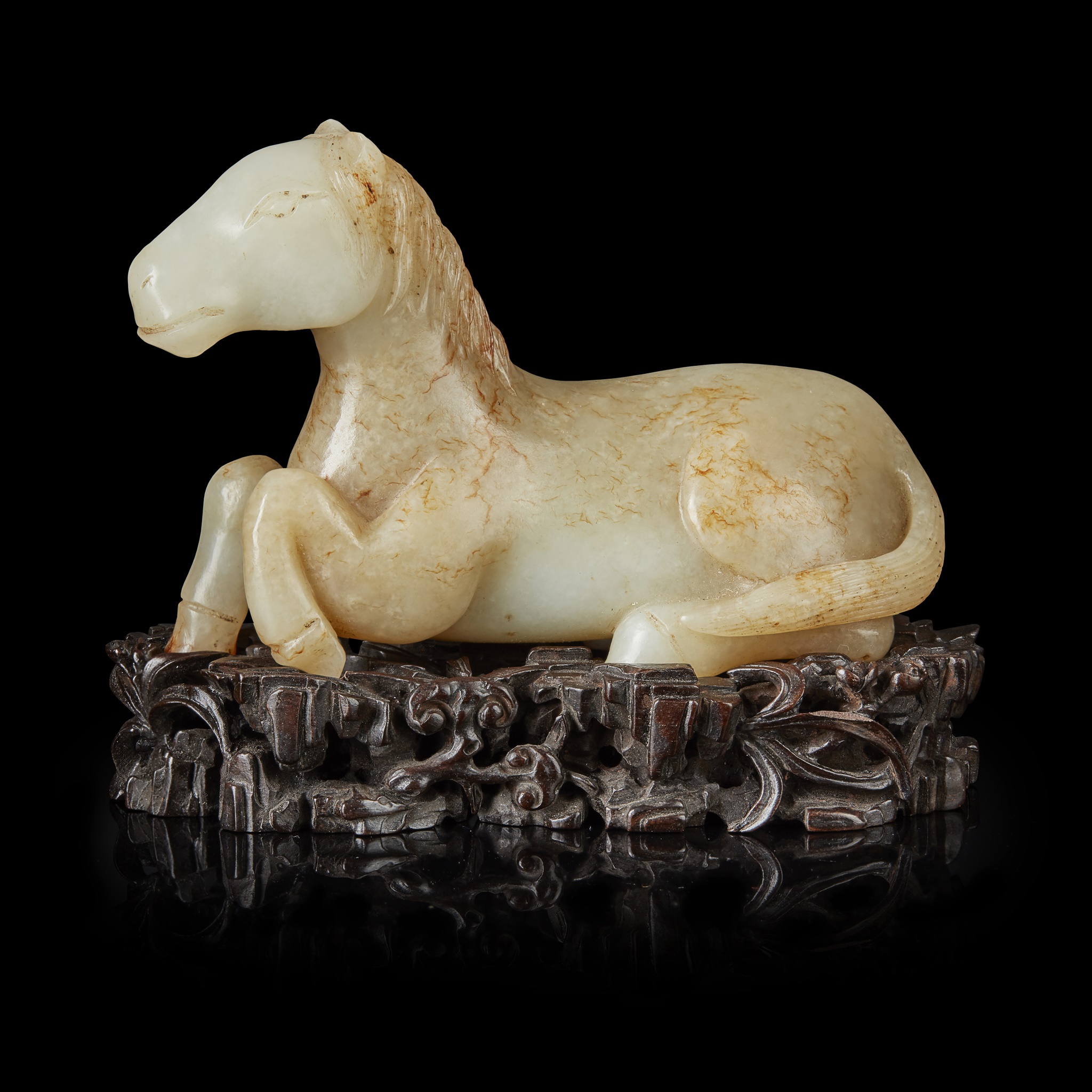 PALE CELADON AND RUSSET JADE CARVING OF A HORSE
