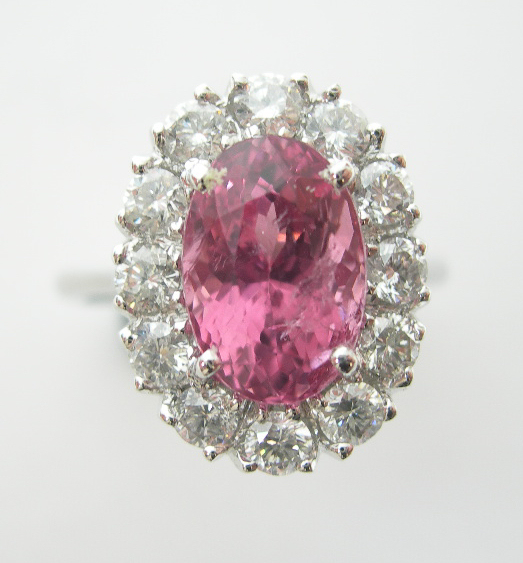 A pink spinel and diamond oval cluster ring,