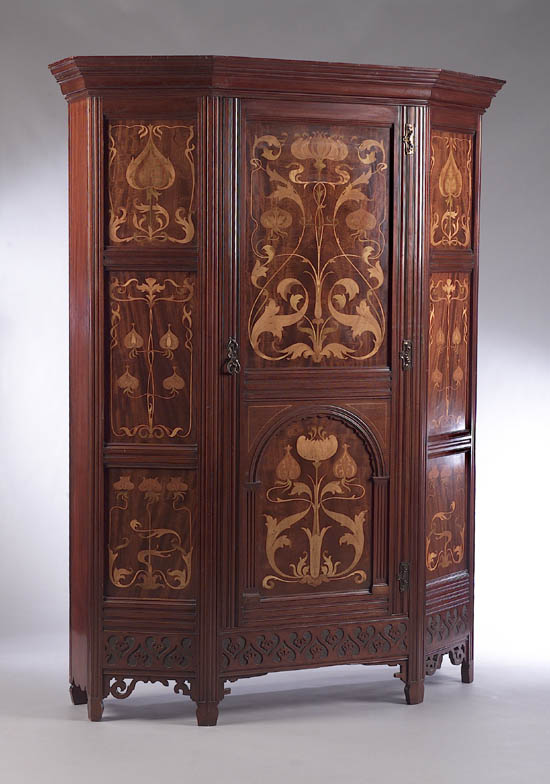 An Art Nouveau mahogany and inlaid cupboard