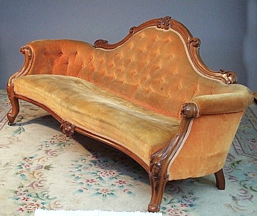 A walnut framed hump back settee