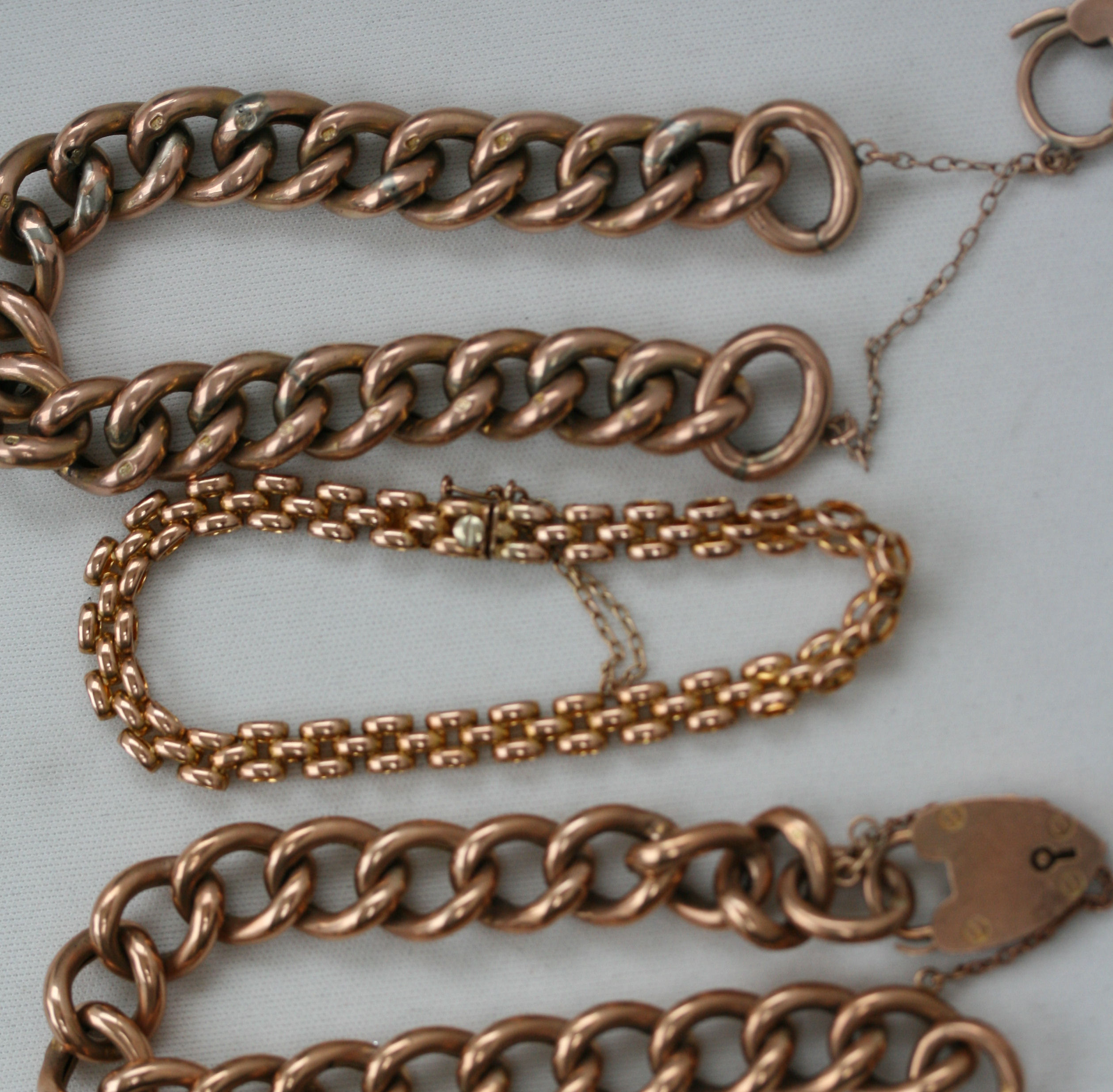 Two curb link bracelets