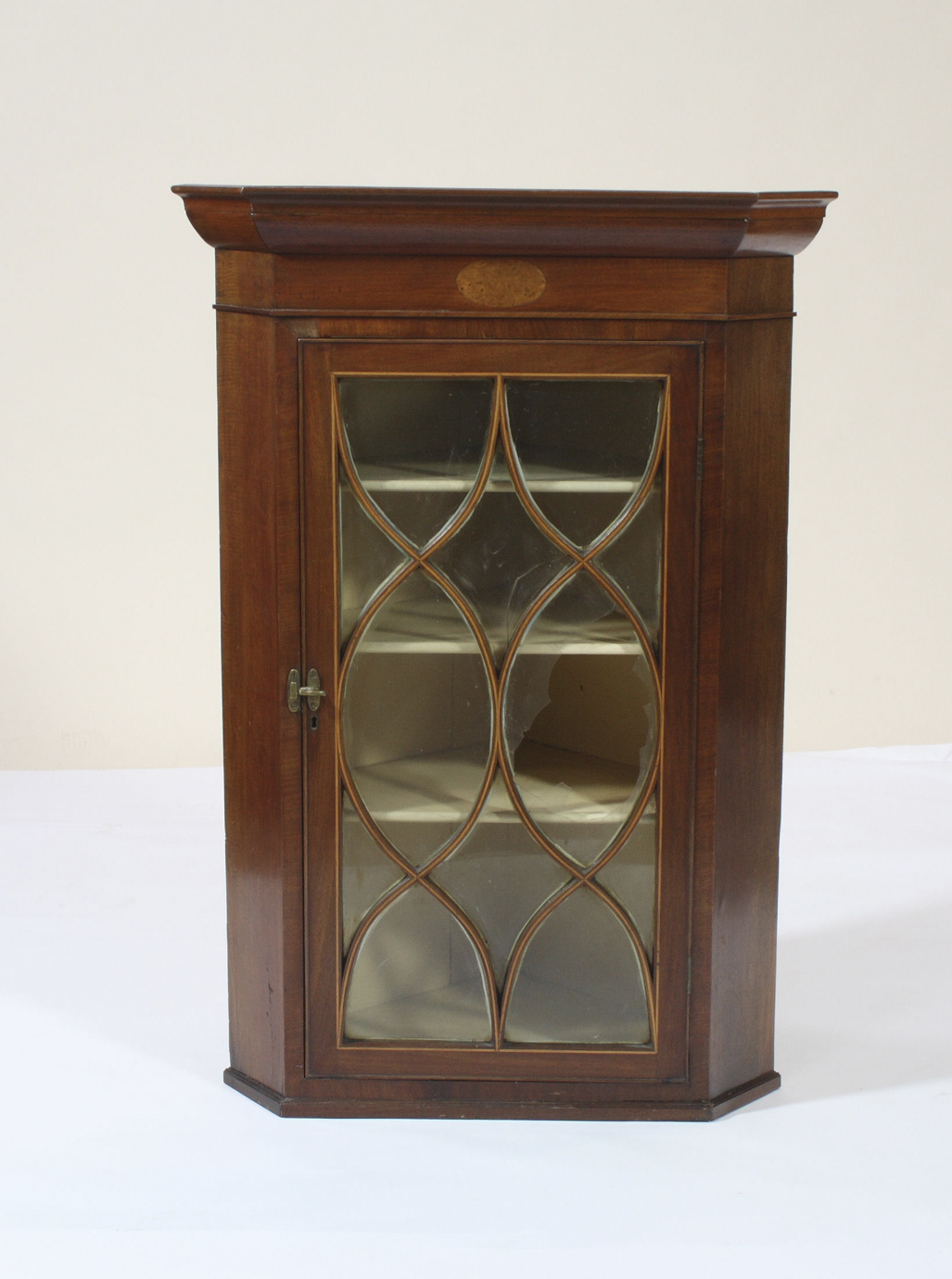 A Georgian mahogany corner cabinet