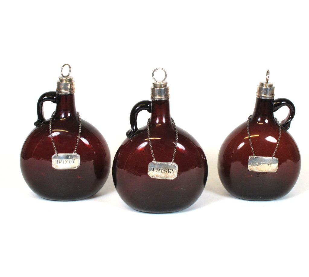 THREE VICTORIAN AMBER GLASS DECANTERS