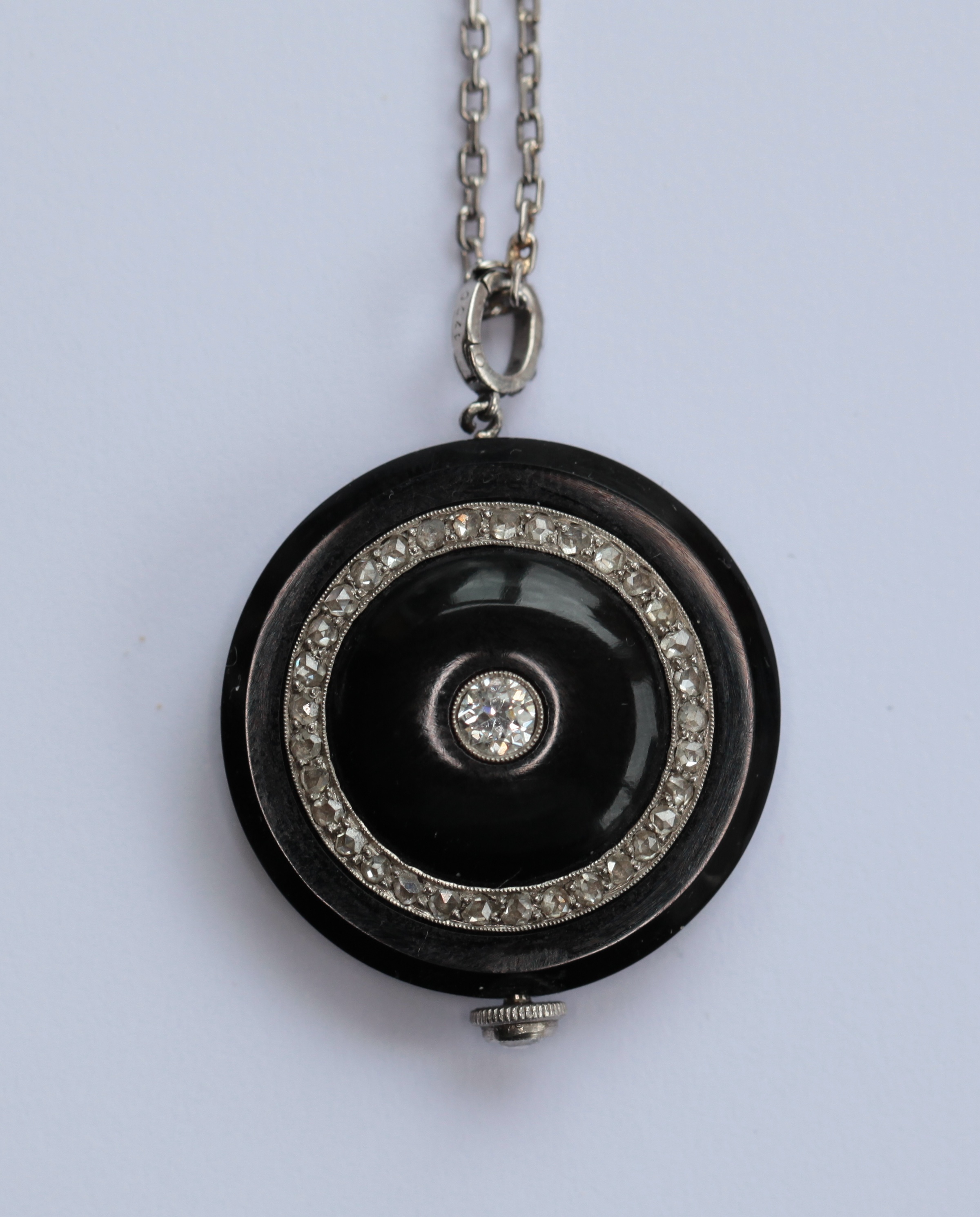 A Cartier style diamond, onyx pendant watch