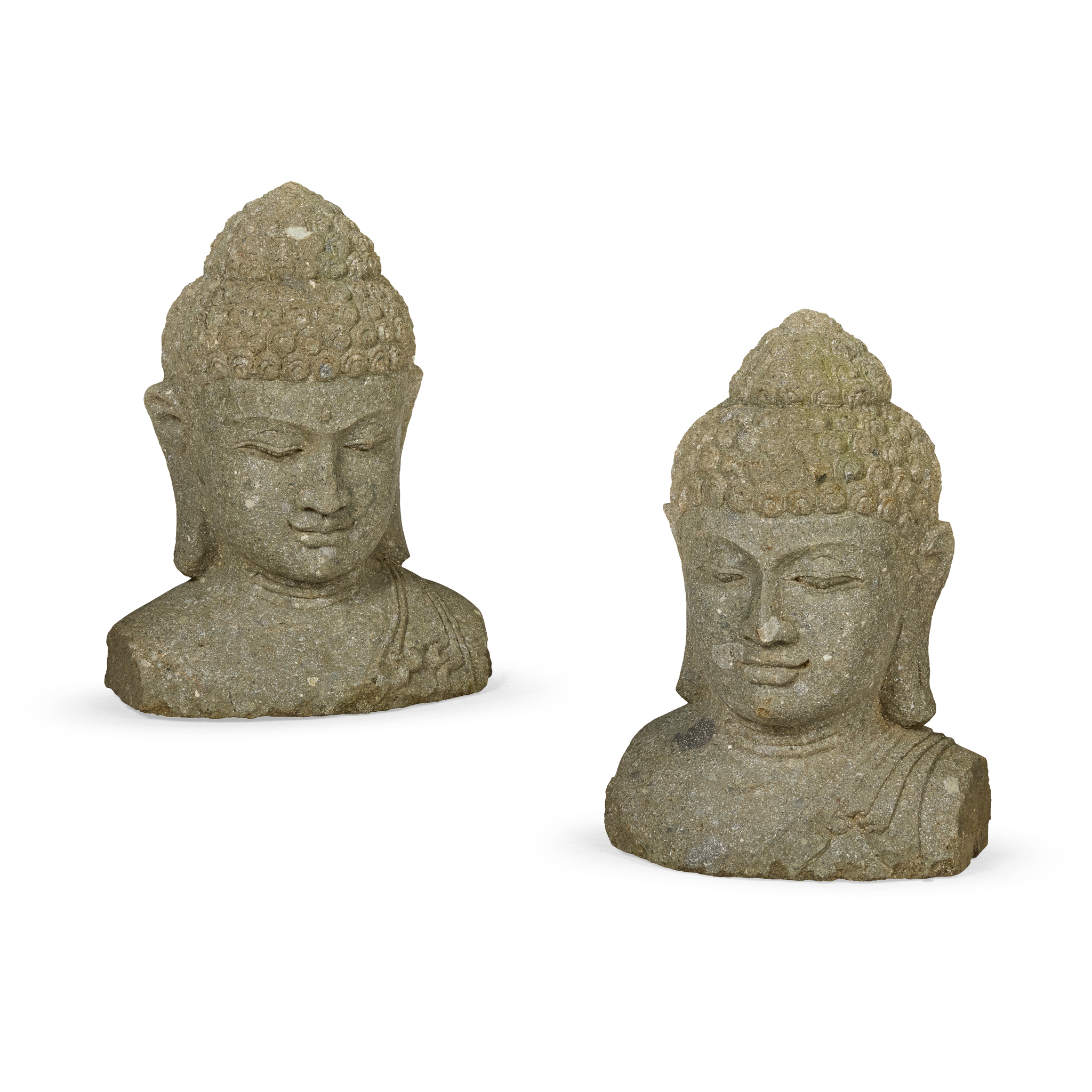 A PAIR OF LARGE CARVED SANDSTONE BUDDHA HEADS