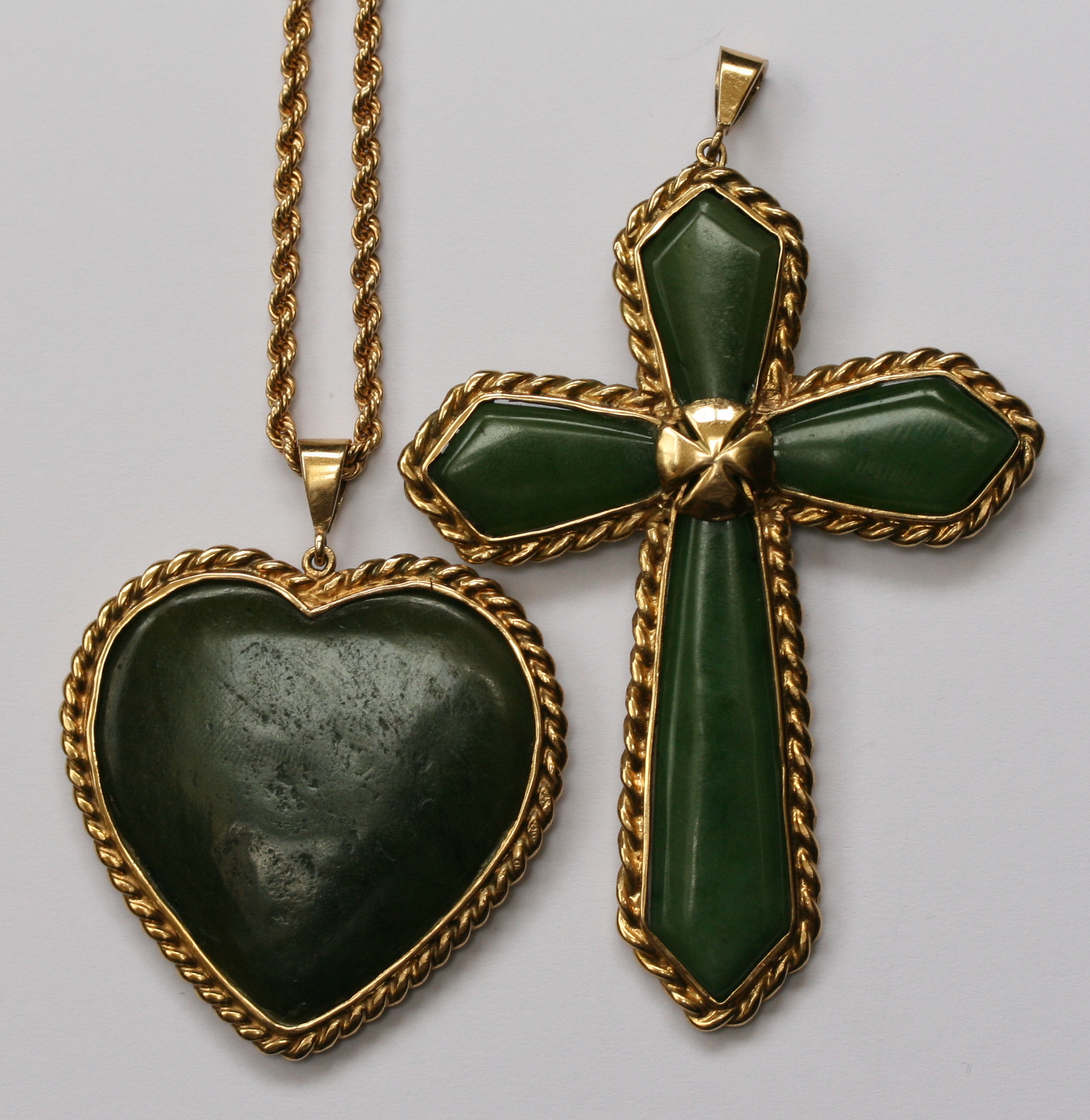 Two gold mounted jade pendants