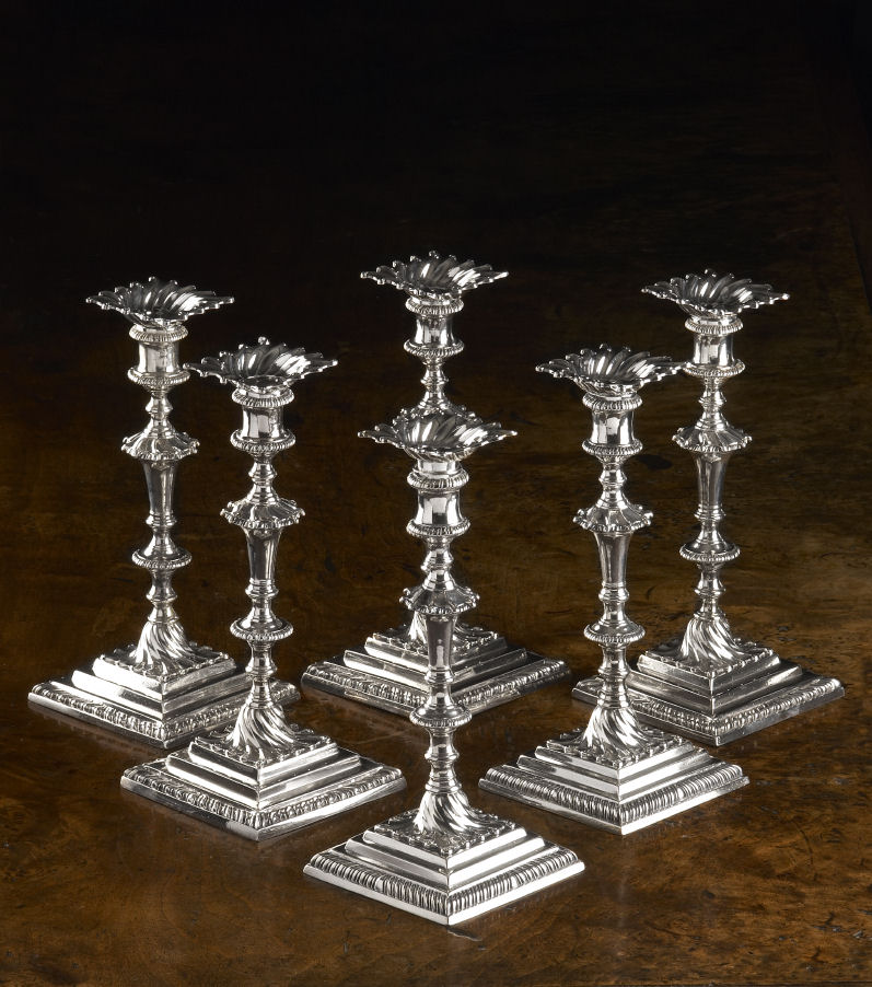 A matched set of six George III cast silver table candlesticks