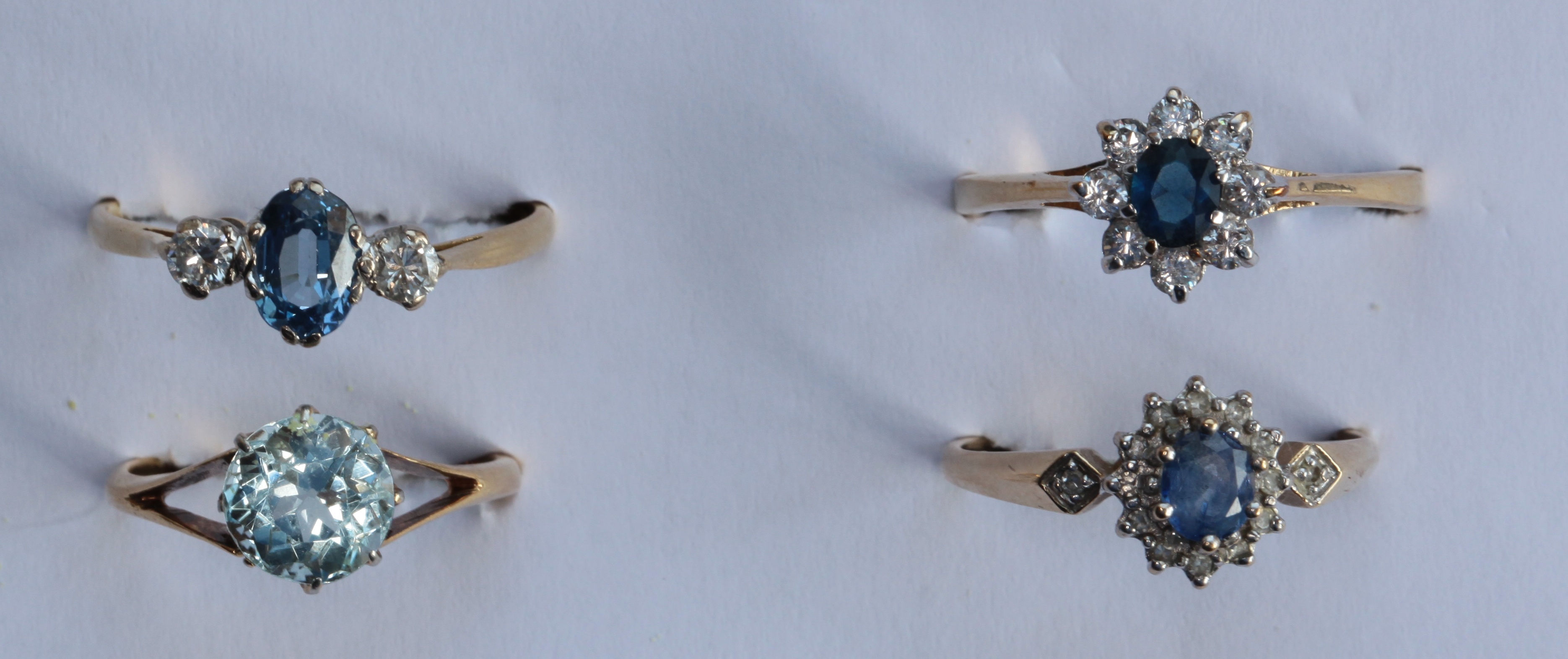 Four assorted gem set rings