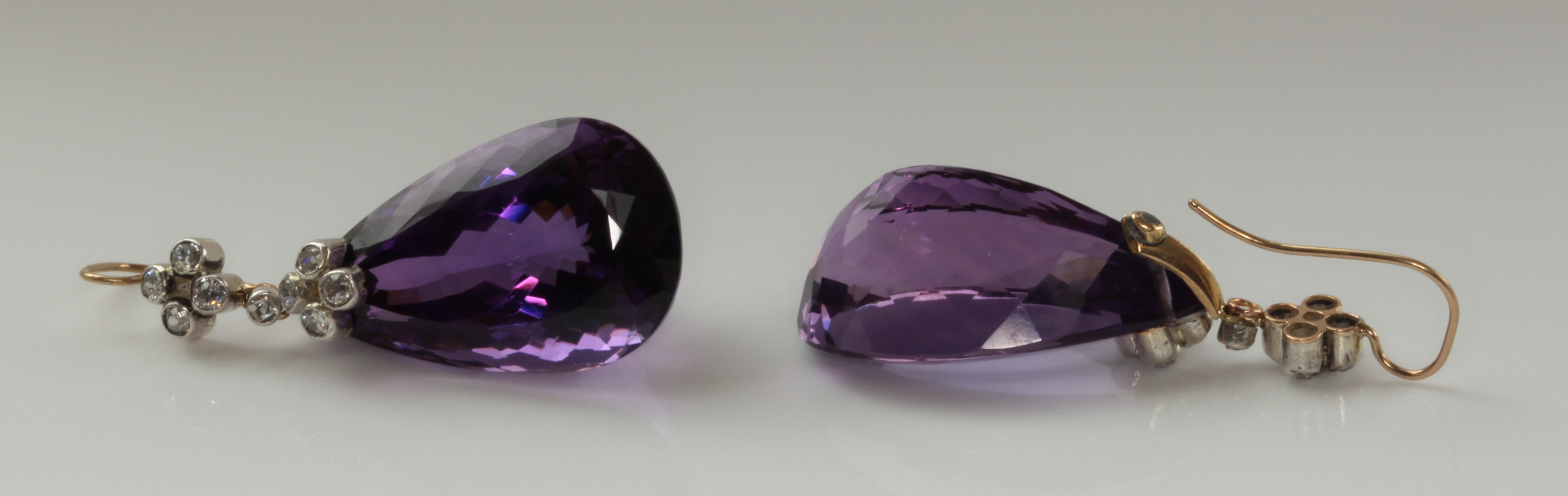 A pair of amethyst and diamond ear pendants