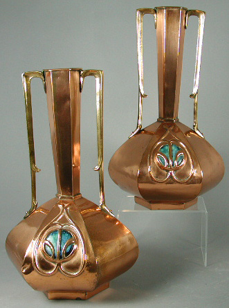 A pair of Art Nouveau copper twin handled urns