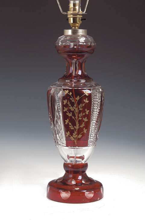 A Bohemian red flashed cut glass table lamp