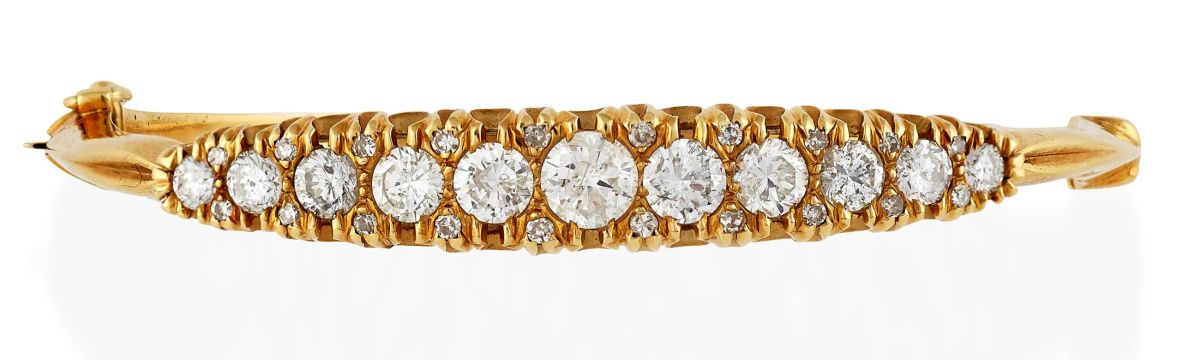 An 18ct gold diamond set hinged bangle
