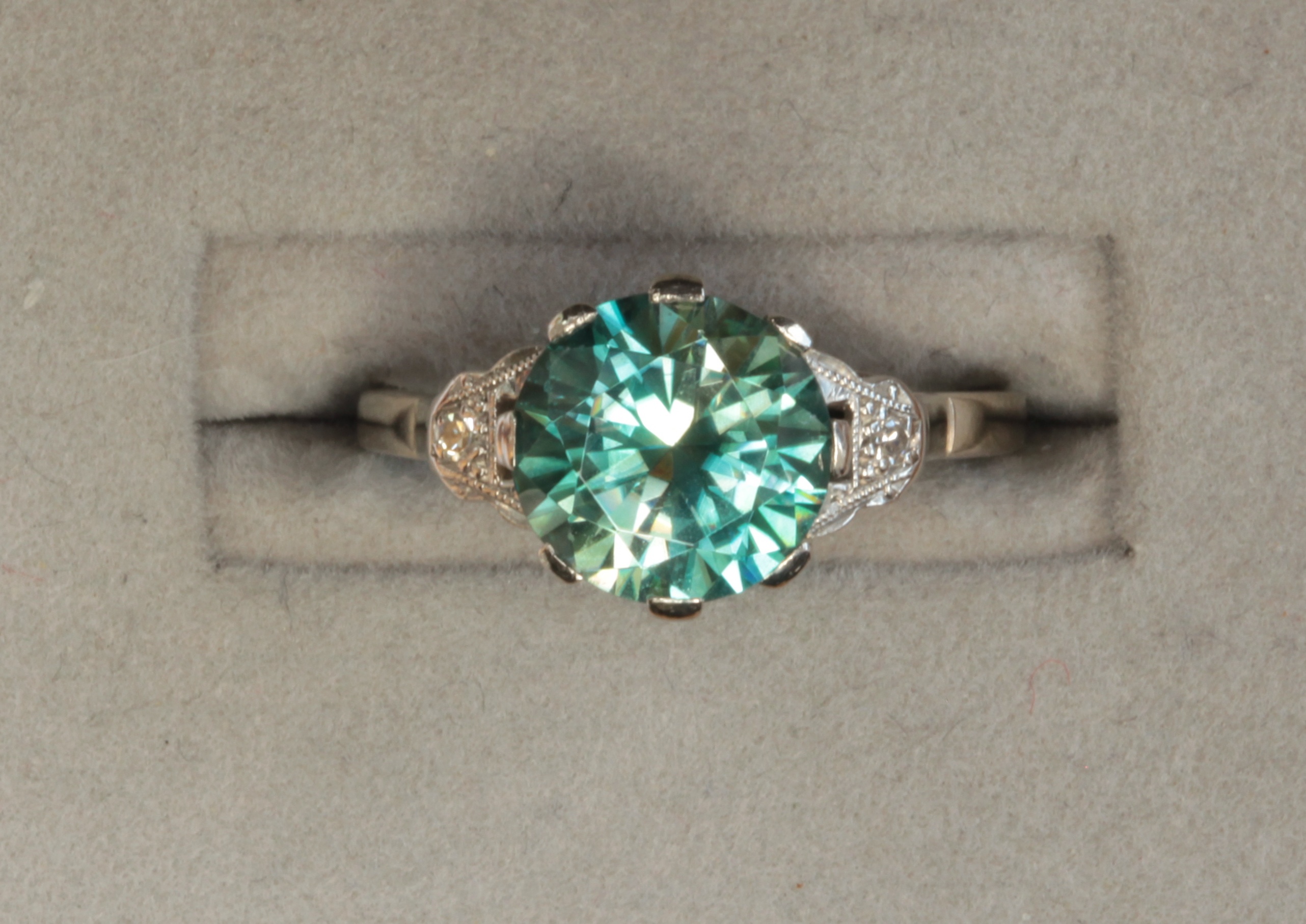 An early 20th century white gold mounted blue Zircon and diamond set ring