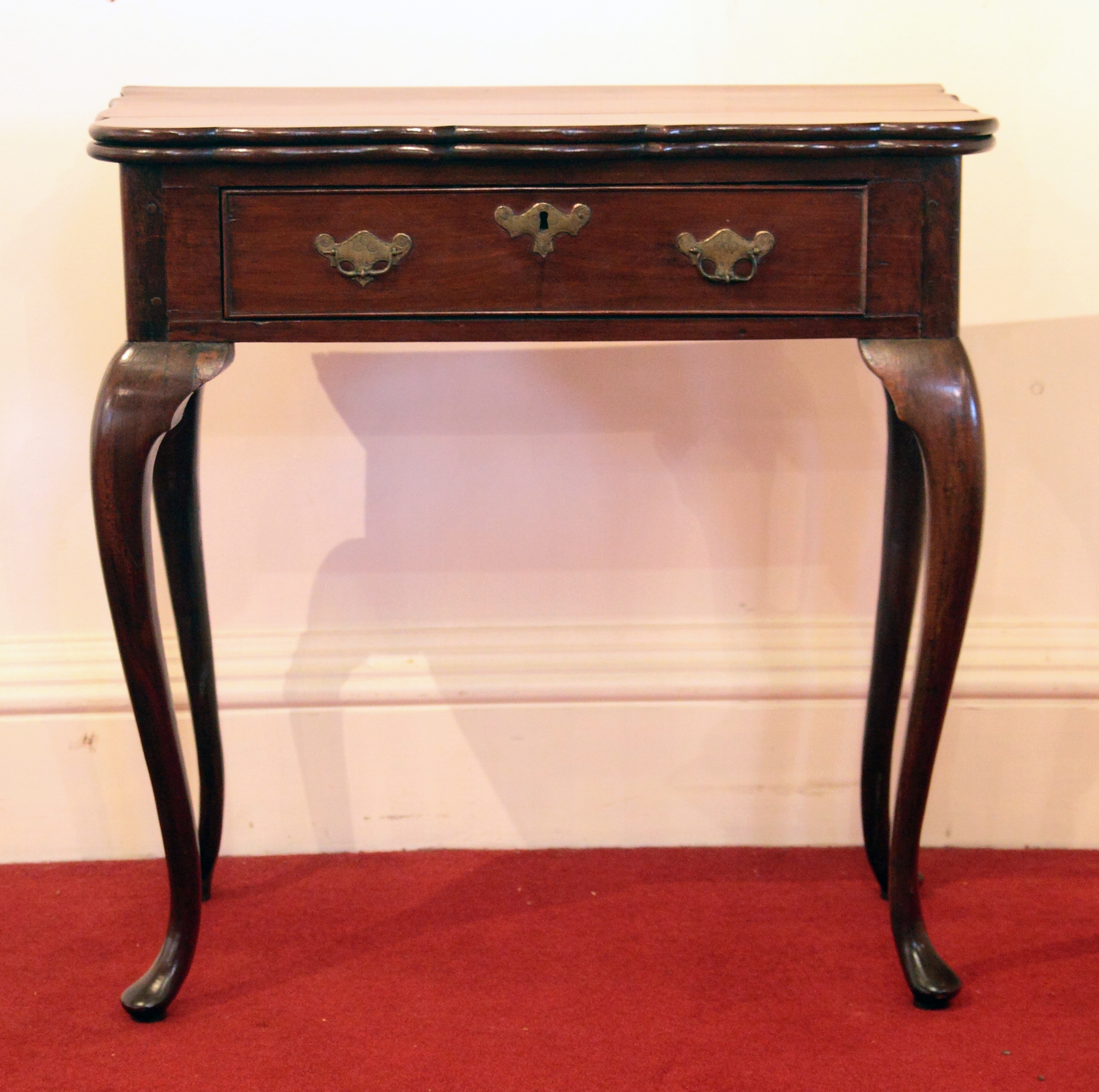 An 18th century Colonial padouk-wood foldover table