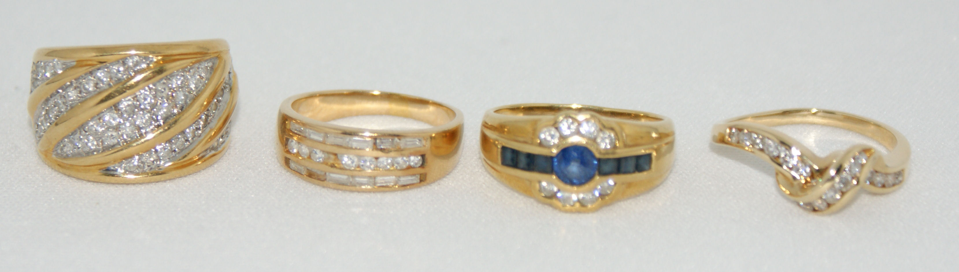 A group of four diamond and gem set rings