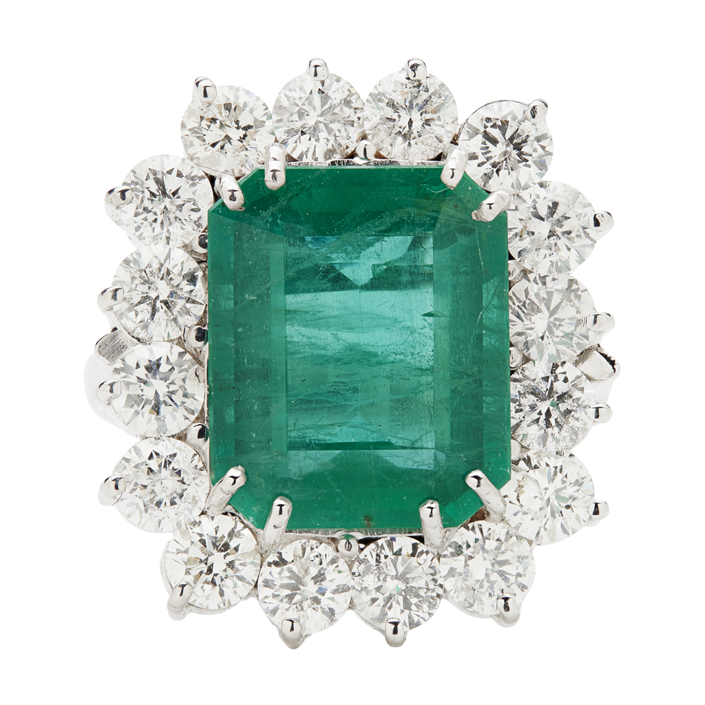 A large emerald and diamond set cocktail ring