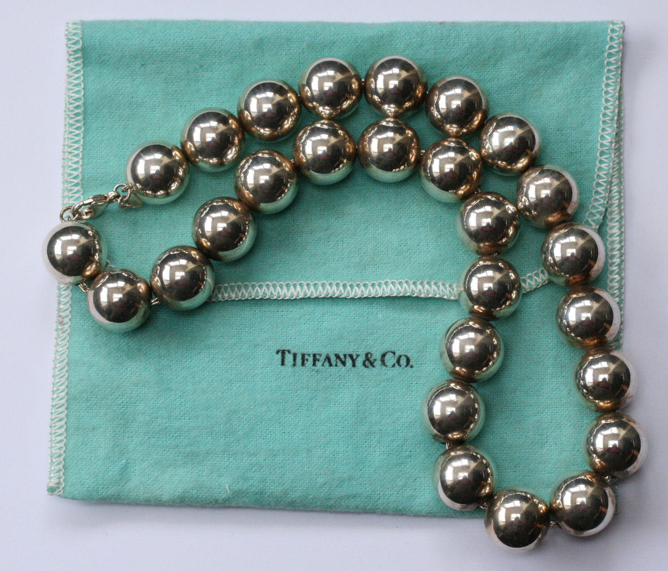 TIFFANY & CO - a silver bead necklace and matching pair of earrings